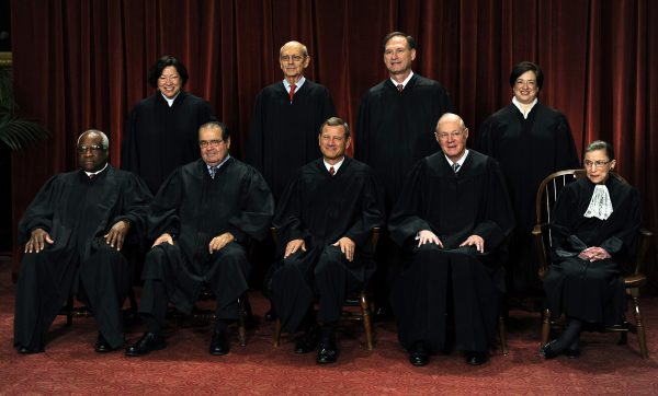 U.S. Supreme Court Justices Clarence Thomas, front row from left to right, Antonin Scalia, John G. Roberts, Anthony Kennedy, Ruth Bader Ginsburg, Sonia Sotomayor, back row from left to right, Stephen Breyer, Sameul Alito, and Elena Kagan sit for a group photograph in the East Conference Room of the Supreme Court in Washington, D.C., U.S., on Friday, Oct. 8, 2010. With the appointment of Kagan, the nine-member supreme court now has three women for the first time. Photographer: Roger L. Wollenberg/Pool via Bloomberg